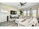 Comfortable living room with large sectional, entertainment center, and natural lighting at 2325 Copper Creek Loop, Longs, SC 29568
