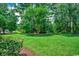 Expansive backyard with verdant lawn and mature trees, creating a private and peaceful retreat at 2450 Marsh Glen Dr. # 112, North Myrtle Beach, SC 29582