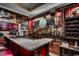 Home bar featuring a granite countertop, custom wood and glass shelving, and eclectic decor at 2450 Marsh Glen Dr. # 112, North Myrtle Beach, SC 29582
