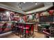 Home bar featuring bar stool seating and custom display shelves and cabinetry at 2450 Marsh Glen Dr. # 112, North Myrtle Beach, SC 29582