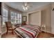 This bedroom features a Murphy bed, wood flooring, and plantation shutters at 2450 Marsh Glen Dr. # 112, North Myrtle Beach, SC 29582