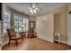 This bedroom features a Murphy bed, wood flooring, and plantation shutters at 2450 Marsh Glen Dr. # 112, North Myrtle Beach, SC 29582