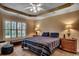 Comfortable bedroom with a ceiling fan, plantation shutters, and carpet flooring at 2450 Marsh Glen Dr. # 112, North Myrtle Beach, SC 29582