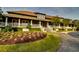 Attractive clubhouse with lush landscaping, a welcoming entrance, and a well-manicured lawn at 2450 Marsh Glen Dr. # 112, North Myrtle Beach, SC 29582