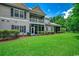 Charming two-story home exterior featuring a well-maintained lawn, screened porch, and sun room at 2450 Marsh Glen Dr. # 112, North Myrtle Beach, SC 29582