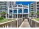 Luxurious home with multiple balconies, a gated entrance, and scenic landscaping and palm trees at 2450 Marsh Glen Dr. # 112, North Myrtle Beach, SC 29582