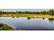 Scenic golf course view with a tranquil lake reflecting the lush green landscape at 2450 Marsh Glen Dr. # 112, North Myrtle Beach, SC 29582