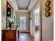 Elegant hallway with hardwood floors and decorative wall accents that leads to sunlit rooms at 2450 Marsh Glen Dr. # 112, North Myrtle Beach, SC 29582