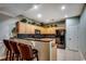 Kitchen featuring maple cabinets, tiled backsplash, bar seating, and modern appliances at 2450 Marsh Glen Dr. # 112, North Myrtle Beach, SC 29582