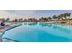 Large pool area with lush palm trees, lounge chairs, and a covered bar area at 2450 Marsh Glen Dr. # 112, North Myrtle Beach, SC 29582