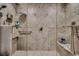 Spacious tiled shower with a built-in bench and dual shower heads at 2450 Marsh Glen Dr. # 112, North Myrtle Beach, SC 29582