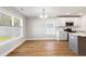Bright dining area with hardwood floors, modern lighting, and a window overlooking the backyard at 2599 Woodcreek Ln., Conway, SC 29527