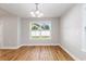 A dining room with hardwood floors, a chandelier, and a window overlooking the front yard at 2599 Woodcreek Ln., Conway, SC 29527