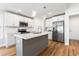 Bright kitchen showcasing an island with sink, stainless steel appliances, and wood flooring at 2599 Woodcreek Ln., Conway, SC 29527