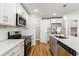 Modern kitchen featuring white cabinets, stainless steel appliances, and a walk-in pantry at 2599 Woodcreek Ln., Conway, SC 29527