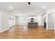 Open-concept living room and kitchen with hardwood floors, kitchen island, and stainless steel appliances at 2599 Woodcreek Ln., Conway, SC 29527
