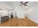 Open-concept living room and kitchen with hardwood floors, island, and stainless steel appliances at 2599 Woodcreek Ln., Conway, SC 29527