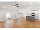 Open-concept living room and kitchen with vaulted ceiling, hardwood floors, and modern finishes at 2599 Woodcreek Ln., Conway, SC 29527