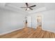 Bedroom with en-suite bath access, tray ceiling, fan, and wood-look floors at 2599 Woodcreek Ln., Conway, SC 29527