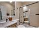 Bright bathroom with double sinks, wood vanity and shower/tub with glass doors at 2602 Clearwater St., Myrtle Beach, SC 29579