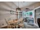 Cozy dining area with a wood table set for four, modern lighting, and a view of the sunroom at 2602 Clearwater St., Myrtle Beach, SC 29579