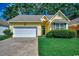 Charming yellow single-story home with a well-manicured lawn, attached garage, and inviting curb appeal at 2602 Clearwater St., Myrtle Beach, SC 29579