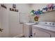 Functional laundry room featuring a washer, dryer, shelving and unique decor at 2602 Clearwater St., Myrtle Beach, SC 29579