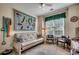 Cozy sitting room with futon, chairs, table, lamp and window with window treatment at 2602 Clearwater St., Myrtle Beach, SC 29579