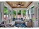 Cozy sun room with wood ceiling, lots of windows, and comfortable wicker furniture at 2602 Clearwater St., Myrtle Beach, SC 29579