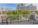 Relaxing balcony featuring comfortable seating and serene views of tropical palm trees and nearby buildings at 2701 Kashton Dr., Myrtle Beach, SC 29577