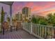 Balcony view showcasing a vibrant sky and city buildings, with palm trees and seating at 2701 Kashton Dr., Myrtle Beach, SC 29577