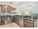 Well-equipped kitchen with stainless steel appliances, granite countertops, and dark wood cabinetry at 2701 Kashton Dr., Myrtle Beach, SC 29577