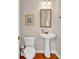 Powder room featuring pedestal sink, gold mirror, and light fixture, providing classic style at 2876 Howard Ave. # C, Myrtle Beach, SC 29577