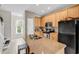 Bright kitchen with stainless steel appliances, wooden cabinets, and large island with sink at 2876 Howard Ave. # C, Myrtle Beach, SC 29577