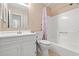 Well-lit bathroom features a vanity with sink, toilet and bathtub with shower at 310 74Th Ave. N # 7, Myrtle Beach, SC 29572