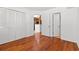 Bedroom with hardwood floors, double closet, and an open doorway to the kitchen at 310 74Th Ave. N # 7, Myrtle Beach, SC 29572