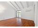 Bedroom features hardwood floors, sliding glass door, closet, and white walls with a window providing natural light at 310 74Th Ave. N # 7, Myrtle Beach, SC 29572