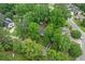 Aerial view of the house showing mature trees, shed, deck, and a driveway at 311 Ashwood Ln., Myrtle Beach, SC 29588