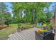 Landscaped backyard featuring seating area, flower beds, mature trees and plenty of space for fun at 311 Ashwood Ln., Myrtle Beach, SC 29588