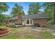 Backyard of a brick home featuring a wood deck with outdoor furniture and grill at 311 Ashwood Ln., Myrtle Beach, SC 29588
