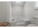 Large soaking tub with a skylight in a white bathroom with white trim at 311 Ashwood Ln., Myrtle Beach, SC 29588