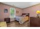 Cozy bedroom with wood-look flooring, natural light, and colorful accents at 311 Ashwood Ln., Myrtle Beach, SC 29588