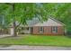 Charming brick and siding home with lush landscaping and a welcoming front porch at 311 Ashwood Ln., Myrtle Beach, SC 29588