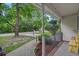 Relaxing porch view with hanging plants, a cozy bench, and a view of the serene street at 311 Ashwood Ln., Myrtle Beach, SC 29588
