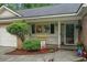 Inviting covered porch with charming decor, potted plants, and a cozy atmosphere at 311 Ashwood Ln., Myrtle Beach, SC 29588