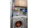 Laundry room with overhead cabinets, washer, dryer, wire shelf, and laundry supplies at 311 Ashwood Ln., Myrtle Beach, SC 29588