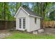 Backyard shed with french doors, a window, and metal tubs on a grass and mulch lot at 311 Ashwood Ln., Myrtle Beach, SC 29588