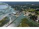 Stunning aerial view of a waterfront community with a marina, restaurants, and scenic marshlands at 3154 Shorecrest Bay Dr., Murrells Inlet, SC 29576