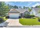 Charming single-story home with a well-manicured lawn, landscaped garden, and attached two-car garage at 3154 Shorecrest Bay Dr., Murrells Inlet, SC 29576