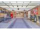 Spacious garage with storage cabinets, refrigerator, ceiling fans, and decorated with sports memorabilia at 3154 Shorecrest Bay Dr., Murrells Inlet, SC 29576